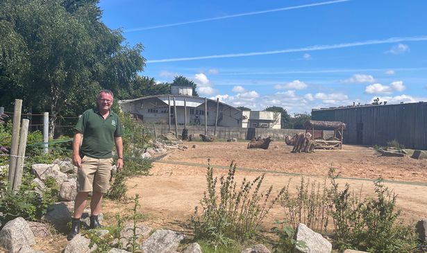 Mike Woolham at Blackpool Zoo with his home in the back ground